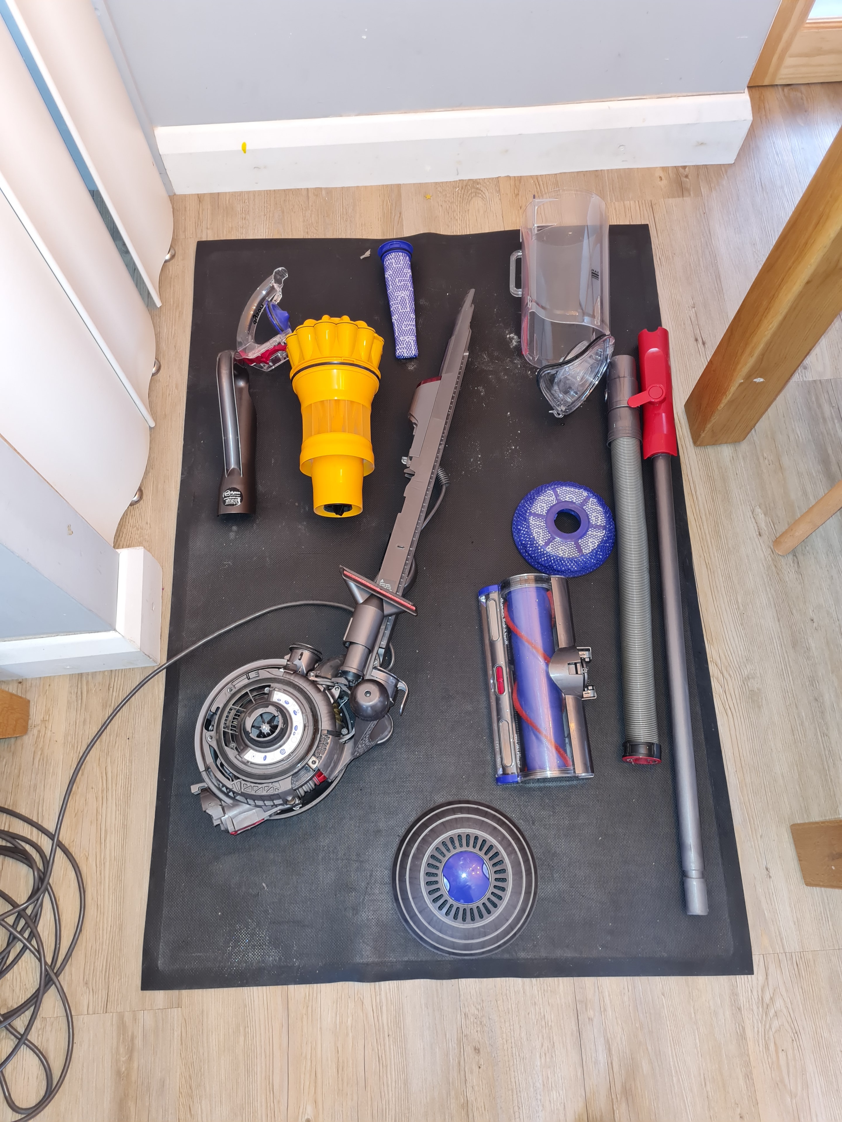 Dyson vacuum cleaner parts laid out for repair